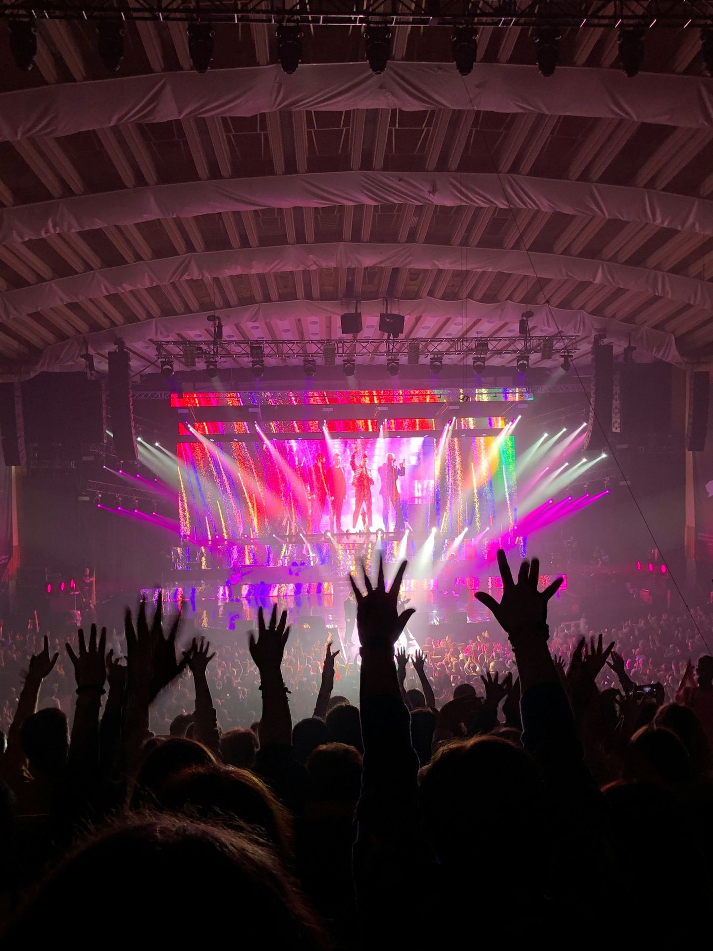 people standing on stage with lights